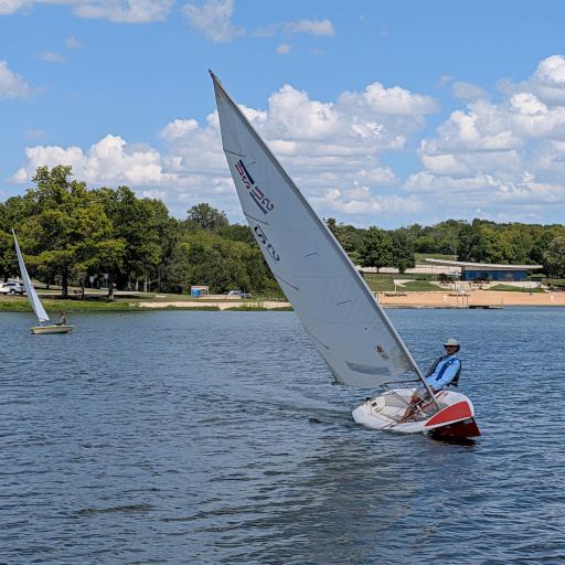 Me sailing my US-1, heeling over tacking back to the finish line